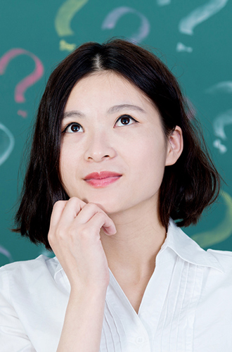 Person looking up with chin in hand in front of a background of question marks