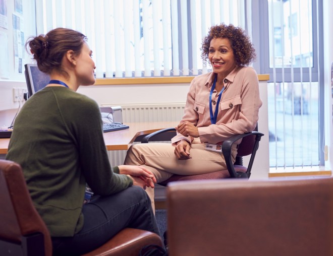 Student talking with school advisor.