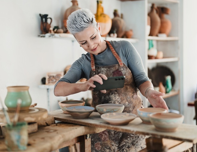 Woman taking picture of pottery