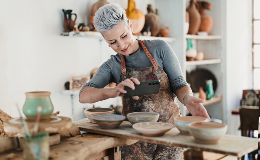 Woman taking picture of pottery