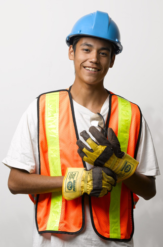 Youth worker wearing a hard hat and safety vest