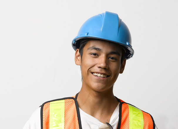 Youth worker wearing a hard hat and safety vest