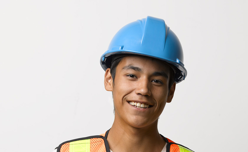 Youth worker wearing a hard hat and safety vest