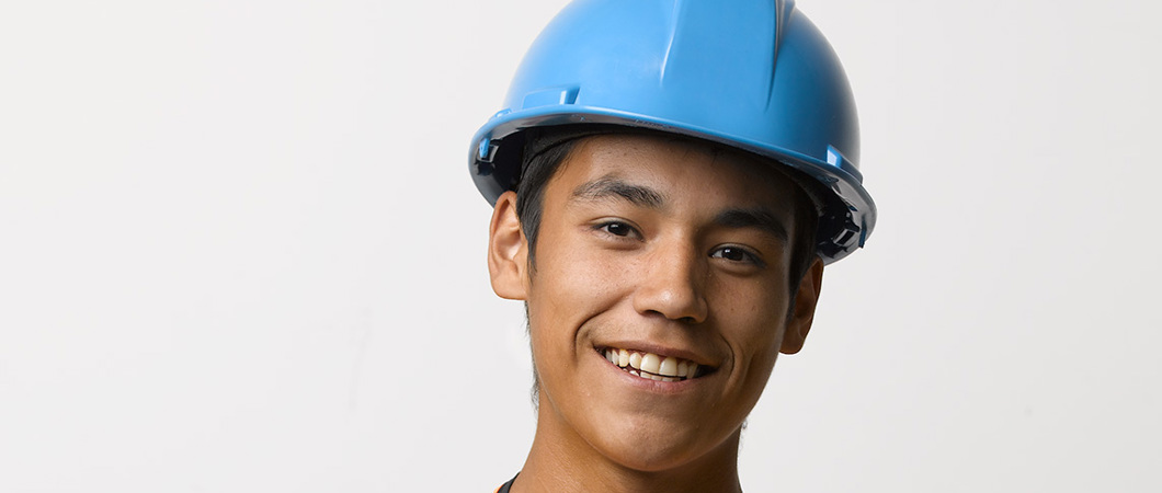 Youth worker wearing a hard hat and safety vest