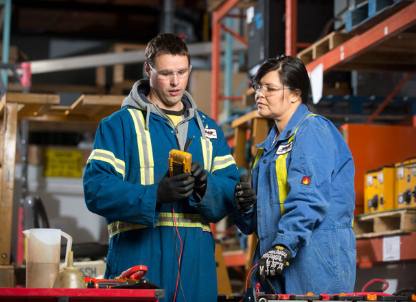 Warehouse staff looking at tools
