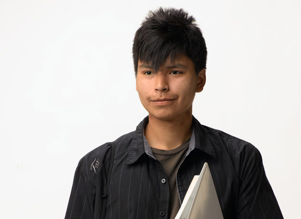 Youth carrying a bag and books