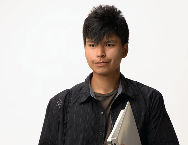 Youth carrying a bag and books