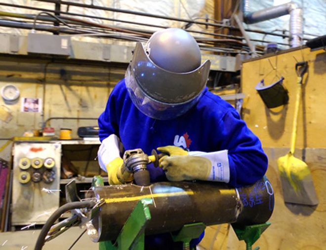 Steamfitter/pipefitter working in a shop