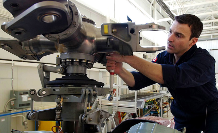 Aircraft maintenance technician working on an airplane engine