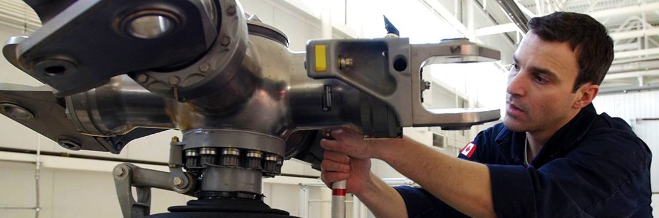 Aircraft maintenance technician working on an airplane engine