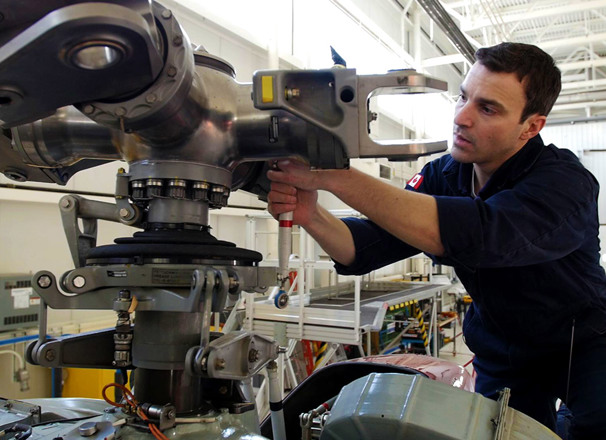Aircraft maintenance technician working on an airplane engine