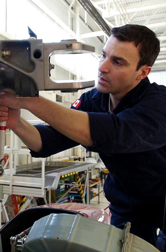 Aircraft maintenance technician working on an airplane engine