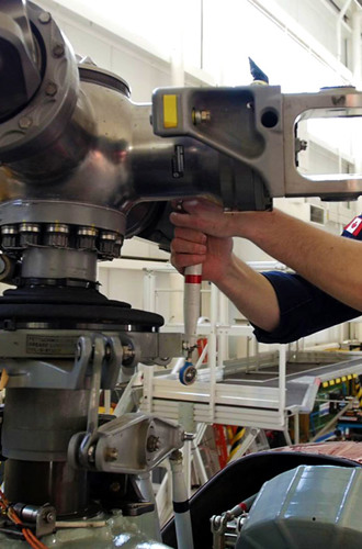Aircraft maintenance technician working on an airplane engine