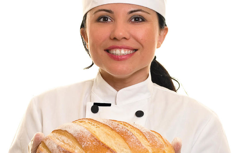 baker folding bread loaf