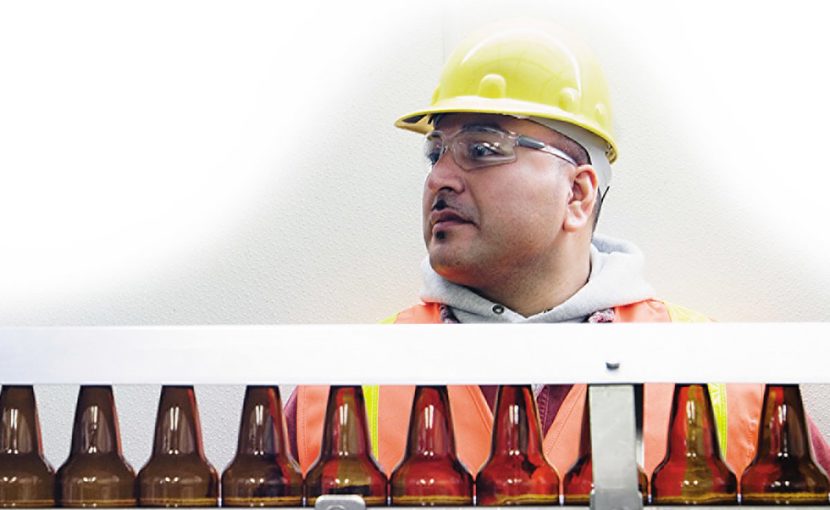 production worker on bottling line