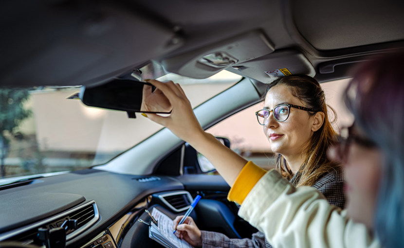 Driver examiner in a car with a test taker