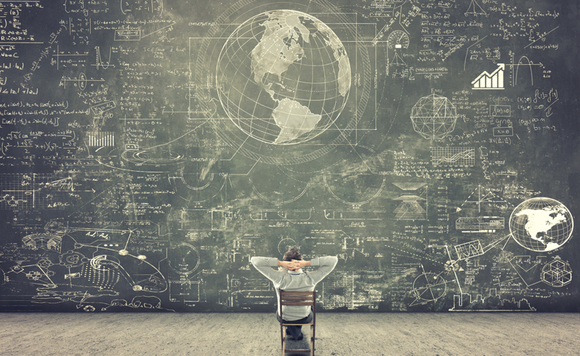 Person looking at a giant chalkboard filled with drawings and text