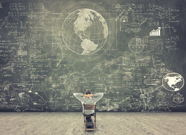 Person looking at a giant chalkboard filled with drawings and text