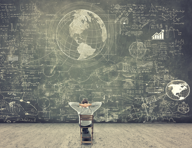 Person looking at a giant chalkboard filled with drawings and text