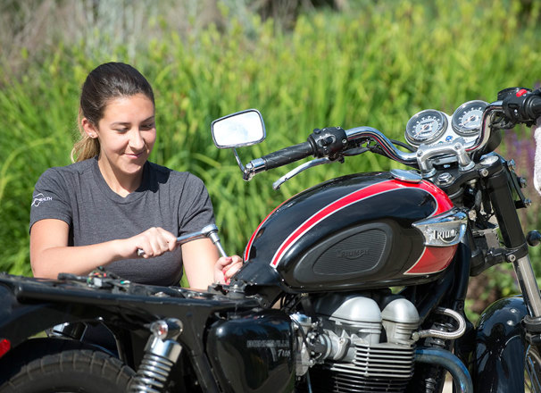 Motorcycle mechanic tuning a motorcycle