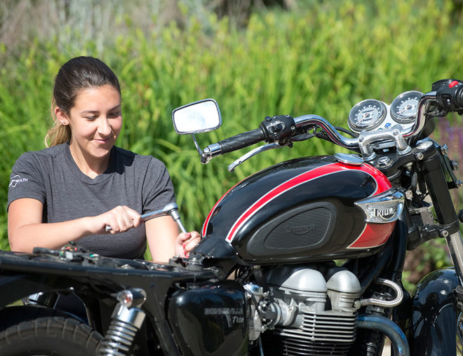 Motorcycle mechanic tuning a motorcycle