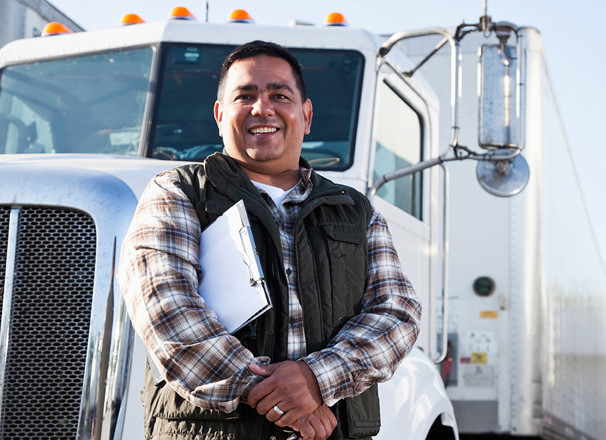 Transport officer standing in front of a semi-trailer truck