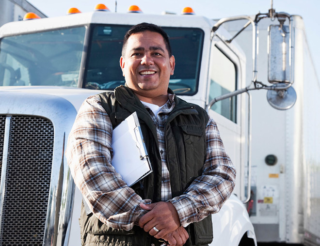 Transport officer standing in front of a semi-trailer truck