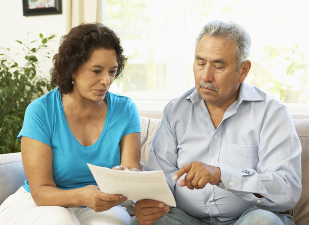 Couple looking at paperwork on the couch