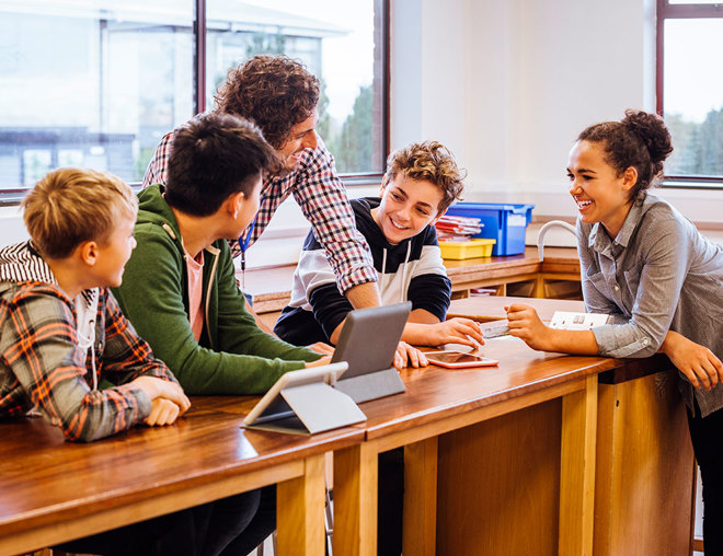 Teacher having a discussion with students in a classroom