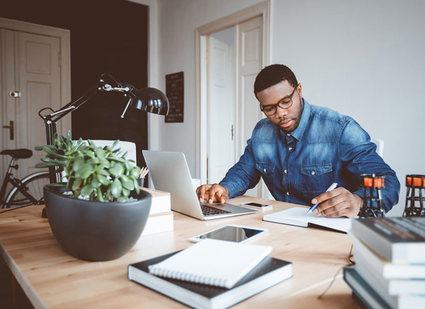 Person working from home office with a laptop