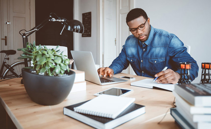 Person working from home office with a laptop
