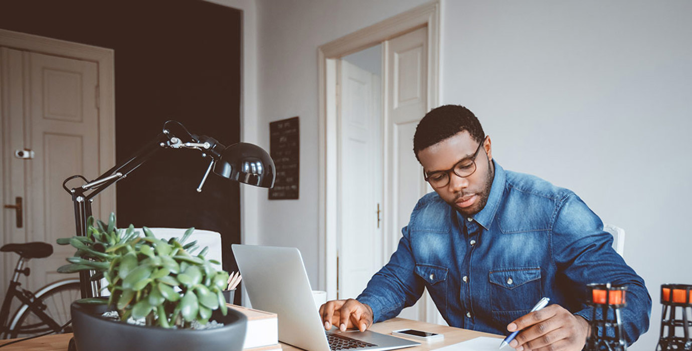 Person working from home office with a laptop