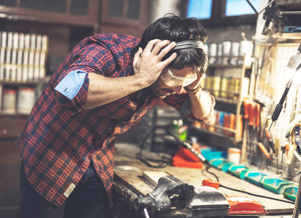 Person grabbing on to ear protection in a workshop