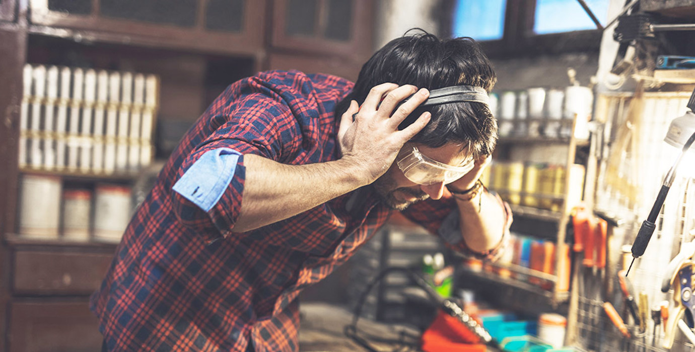 Person grabbing on to ear protection in a workshop