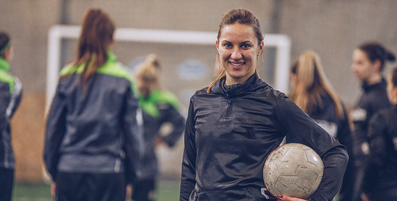 Soccer player holding a ball