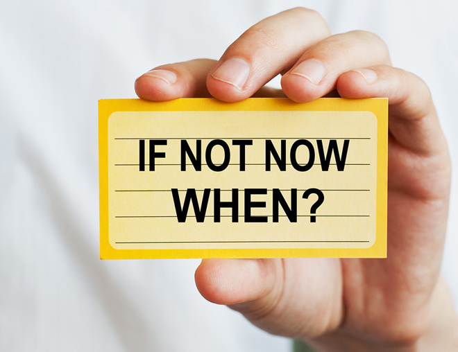 Hand holding up an index card with the message, "If not now, when?"
