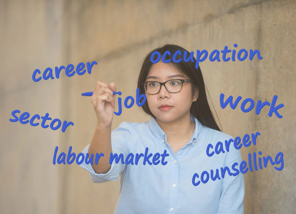Person writing career terms on glass with a marker