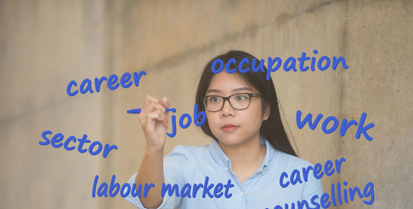 Person writing career terms on glass with a marker