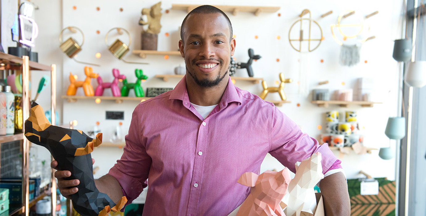 Entrepreneur holding a box of origami in a store