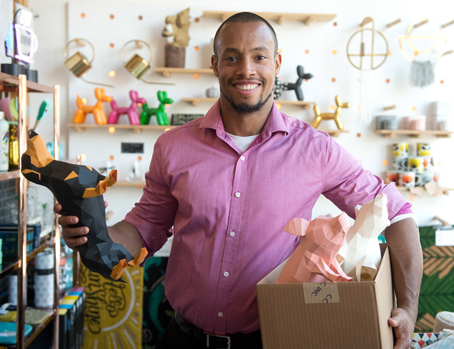 Entrepreneur holding a box of origami in a store