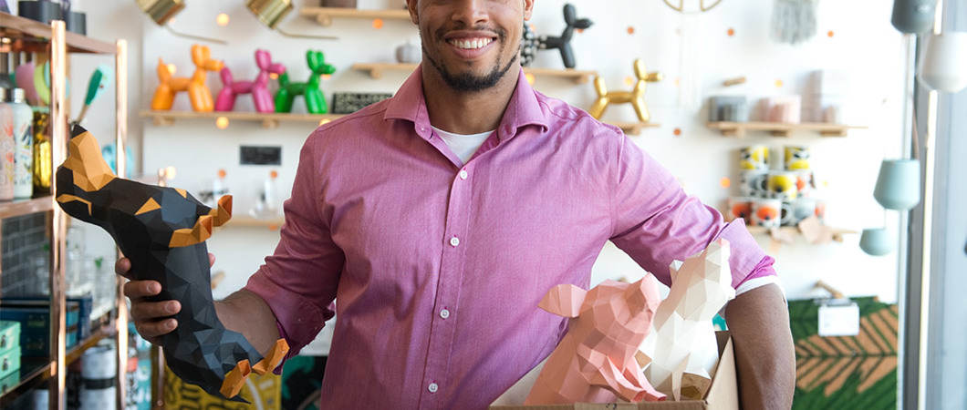 Entrepreneur holding a box of origami in a store