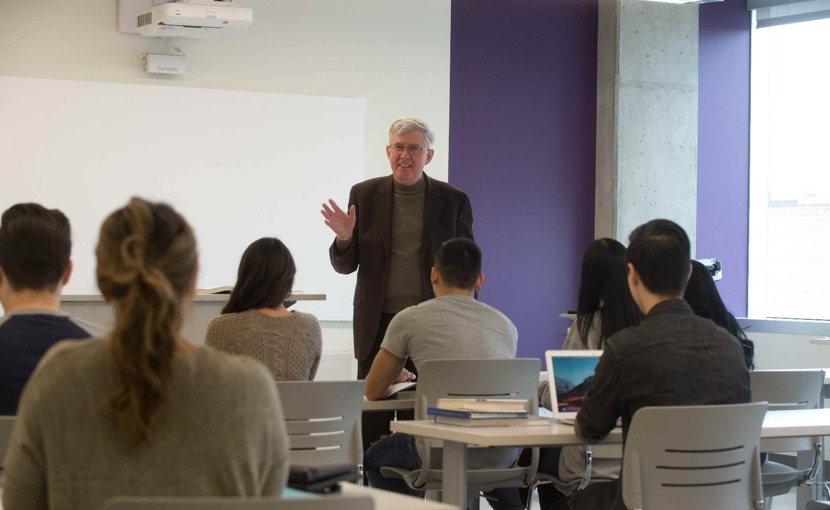 Post-secondary classroom as seen from the back, with instructor facing the class