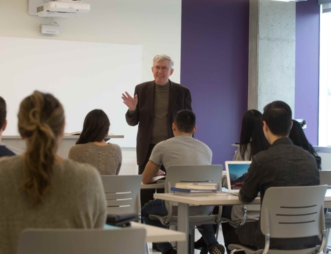 Post-secondary classroom as seen from the back, with instructor facing the class