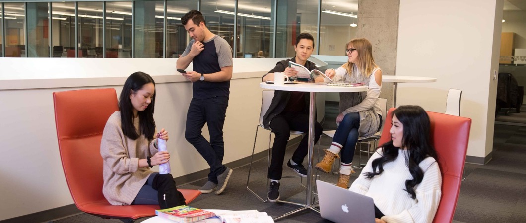 Students hanging out in a small common area on campus