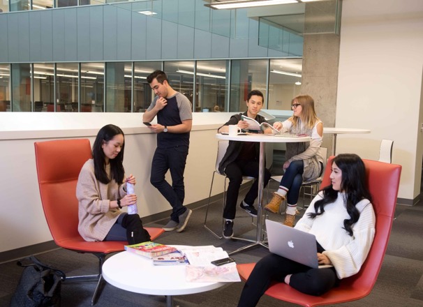Students hanging out in a small common area on campus