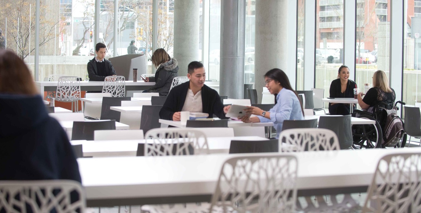 Students sitting in a large common study area