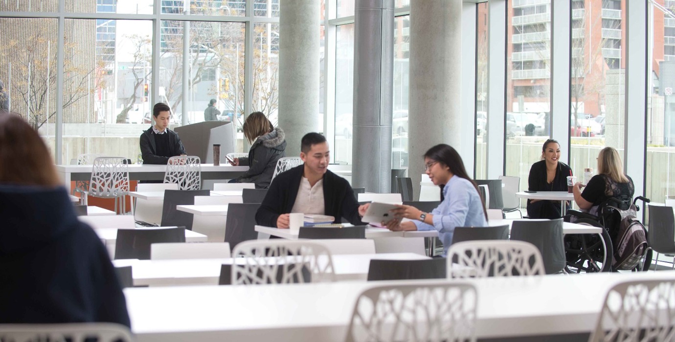 Students sitting in a large common study area