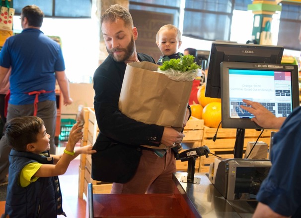 Parent with children at the grocery checkout