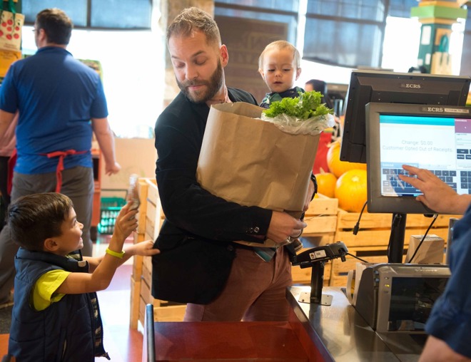 Parent with children at the grocery checkout