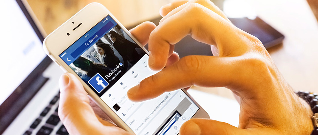 Closeup of hands holding a mobile phone and scrolling